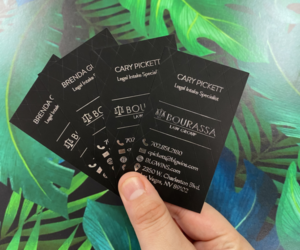 Close-up of raised spot UV business cards with legal firm branding
