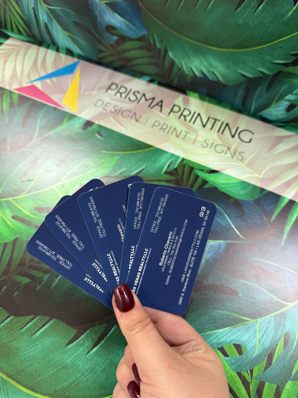 Hand holding premium navy blue visiting cards by Prisma Printing