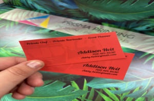 Vibrant red premium coated business cards held for display