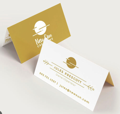 Stylish fold-over business card with a gold logo and minimalist layout