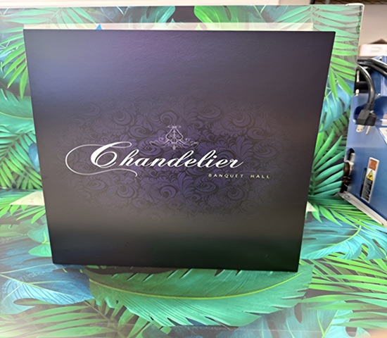Spot UV finish highlighting 'Chandelier Banquet Hall' logo